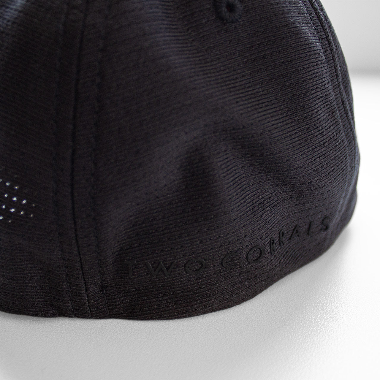 Our signature RUN cube design on a performance running hat (back view) that is part of our RUN gift box set from TWO CORRALS Lifestyle Running Brand