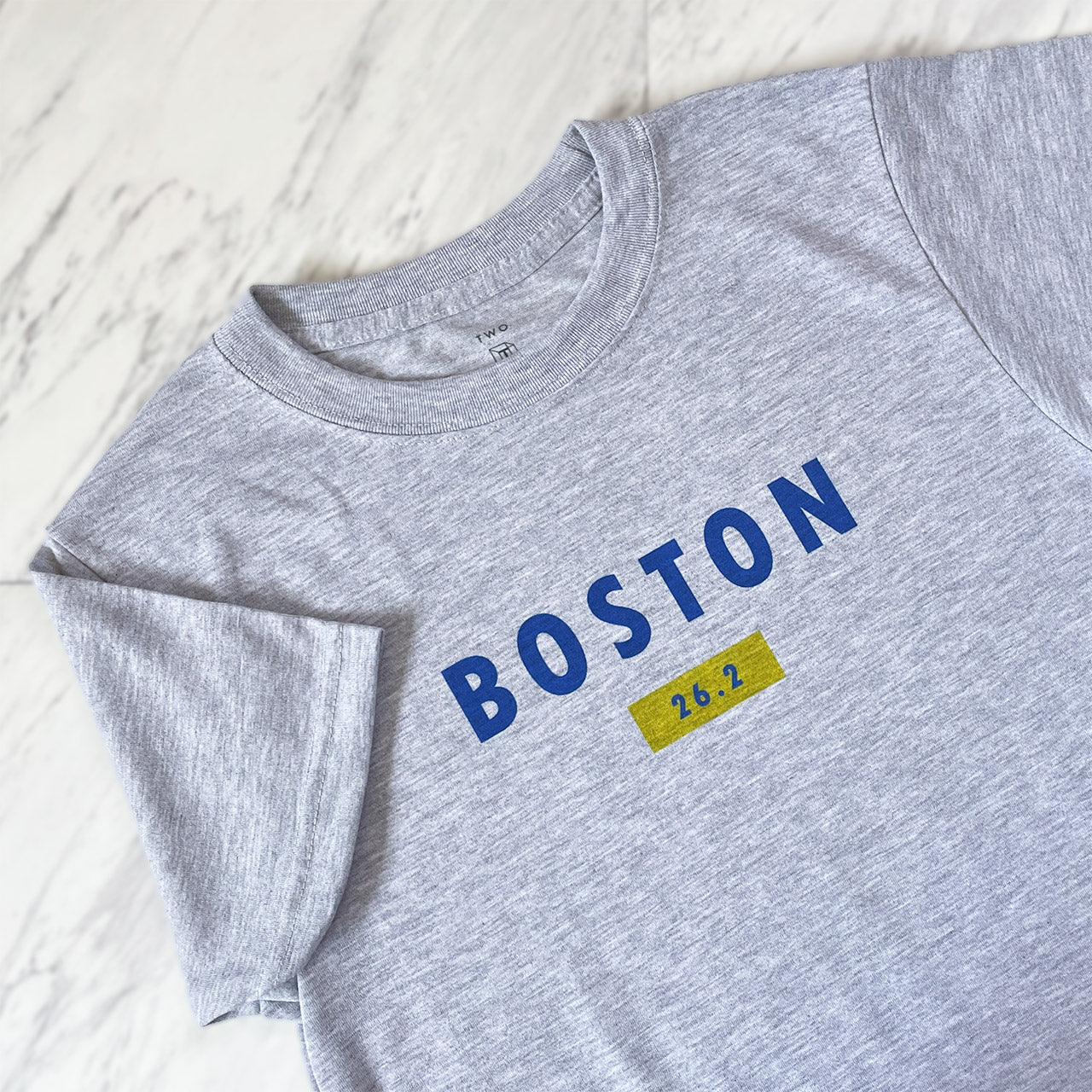 Boston 26.2 performance running short sleeve shirt from TWO CORRALS Lifestyle Running Brand, minimalistic marathon shirt with Boston in blue and 26.2 in blue and yellow