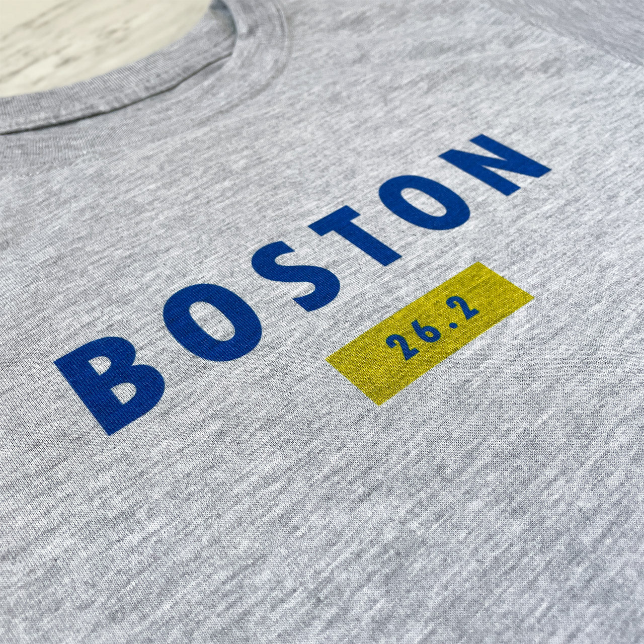 Boston 26.2 performance running short sleeve shirt from TWO CORRALS Lifestyle Running Brand, minimalistic marathon shirt with Boston in blue and 26.2 in blue and yellow