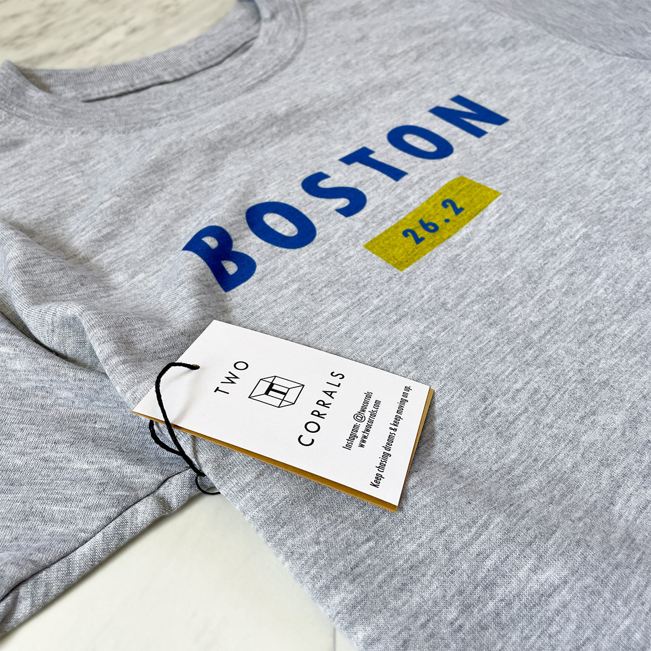 Boston 26.2 performance running short sleeve shirt from TWO CORRALS Lifestyle Running Brand, minimalistic marathon shirt with Boston in blue and 26.2 in blue and yellow