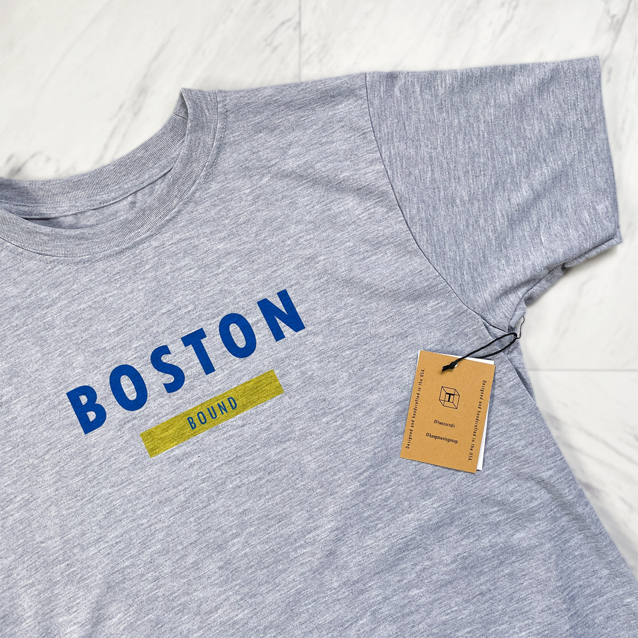 Boston bound (variation 1) performance short sleeve shirt from TWO CORRALS Lifestyle Running Brand, minimalistic Boston Bound shirt with Boston in blue and bound in yellow