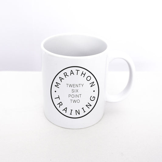 Marathoner mug from TWO CORRALS Lifestyle Brand. This mug has our original design Marathon Training Twenty Six Point Two printed on both sides.