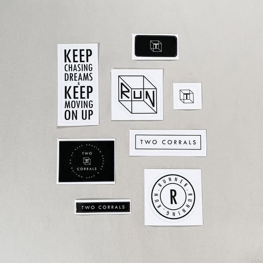 Large pack of minimalistic running stickers from TWO CORRALS Lifestyle Running Brand, sticker pack includes our signature RUN RUNNER RUNNING design, RUN Cube design, brand tagline "KEEP CHASING DREAMS & KEEP MOVING ON UP" and more