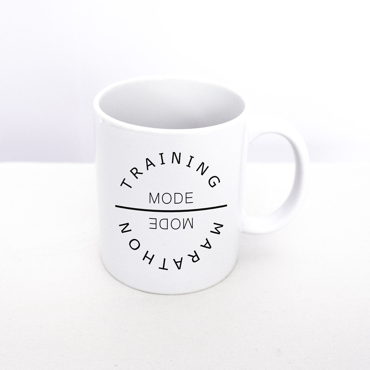 Marathon mug from TWO CORRALS Lifestyle Running Brand. Our original design is printed on both sides TRAINING MODE MARATHON MODE